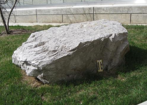 boulder 21 is limestone and is located on the top of the stairs on the west side of Slawson Hall.